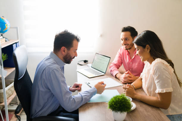 istock Hispanic couple buying flights with a sales agent 1316969860