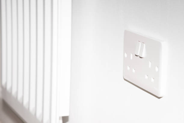 istock A United Kingdom standard wall socket on a white wall next to radiator 1316974156