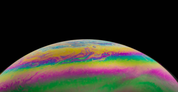 istock Blurred colourful soap bubble close up on black background. Creative background. Concept of space and creativity. Imitation of an unknown planet. 1316975083