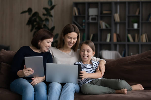 istock Happy three generations of women relax using gadgets 1316977307