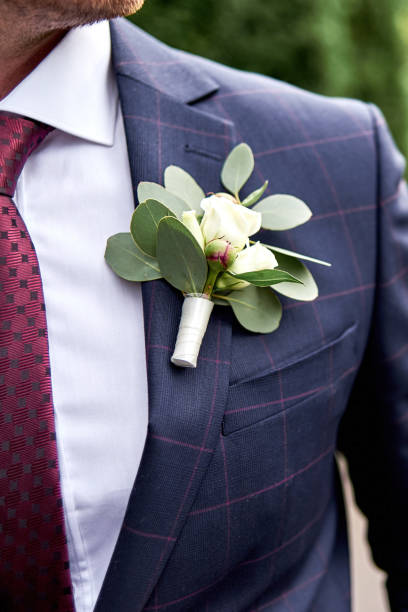 Groom in white shirt, plaid suit and tie with buttonhole on green background outdoors, copy space. Wedding concept Groom in white shirt, plaid suit and tie with buttonhole on green background outdoors, copy space. Wedding concept buttonhole flower stock pictures, royalty-free photos & images
