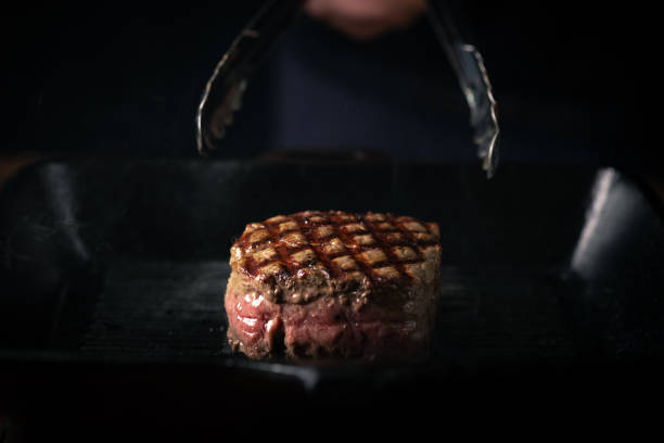 istock The process of grilling beef tenderloin in a pan, filet Mignon steak medium rare 1316979674
