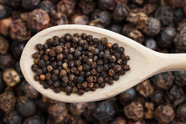 Black pepper background. Peppercorn texture. Food ingredient spices pattern.