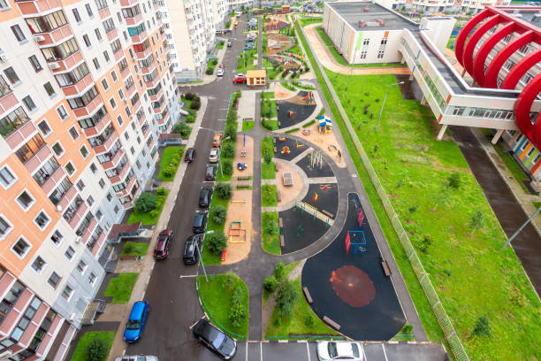 Aerial view apartment complex with children playground and appartment building exterior in mixed-use urban multi-family residential district area development. Residential settings concept