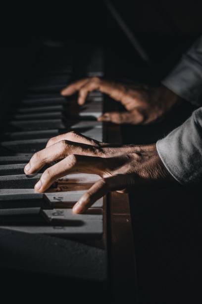 istock Close-up of a hand playing the piano 1316982556