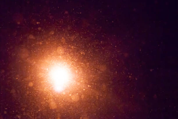 istock Blurred background. Snow falls from the night sky. Illuminated snowflake lantern. Night, winter evening 1316983949
