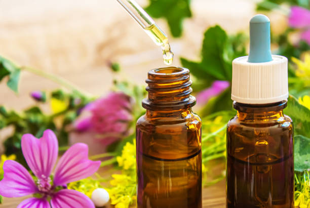 istock medicinal herbs, oils in small bottles homeopathy. selective focus 1316985123