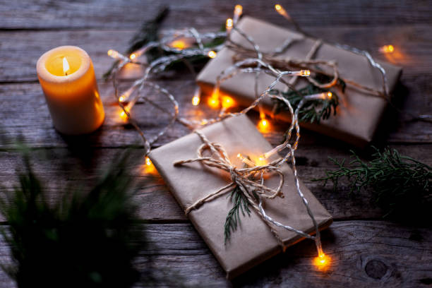 istock Gift packages wrapped in craft paper, a candle and small light bulbs. 1316986114