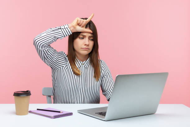 istock Depressed upset woman office worker showing loser gesture communicating on video call, sad about her dismissal, desperate about unlucky day 1316986702