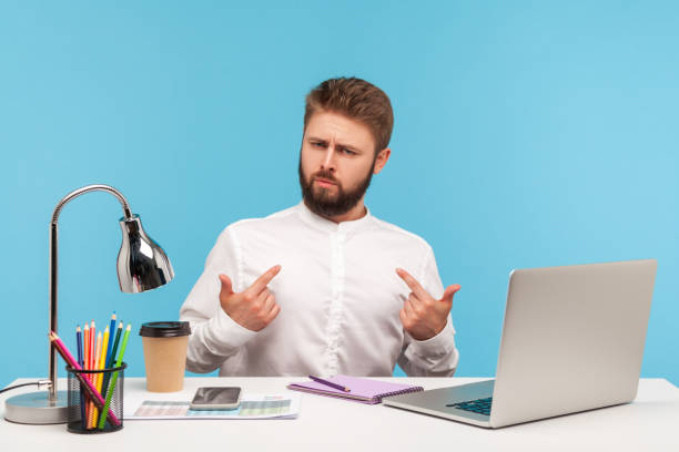 istock This is me! Self confident successful man employee sitting office workplace with laptop on desk, pointing himself and boasting promotion, job achievements 1316986750