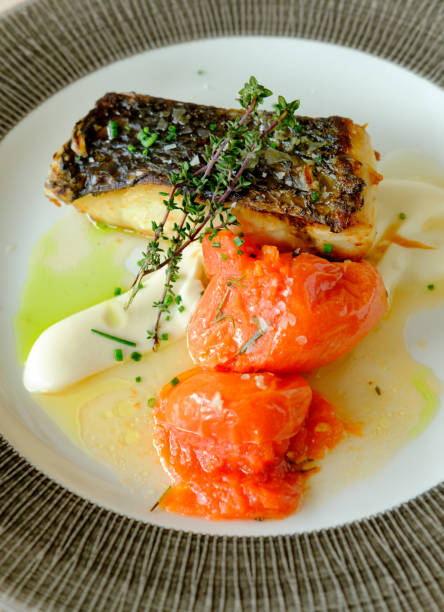 istock Grilled fish with cauliflower cream and roasted tomatoes 1316986882