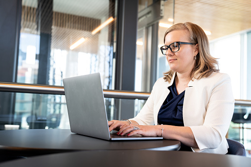 Business woman in modern office working and concentrate at her computer screen