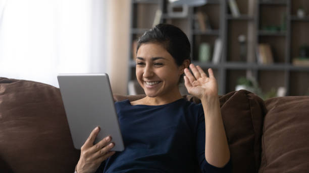 istock Smiling Indian woman talk on video call on tablet 1316991398