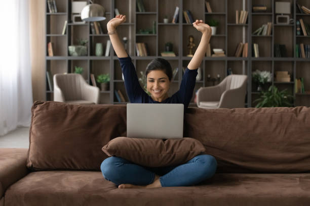istock Overjoyed Indian woman triumph with good news on computer 1316991452