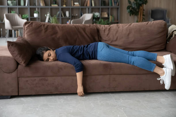 istock Exhausted Indian woman fall asleep on couch at home 1316991505