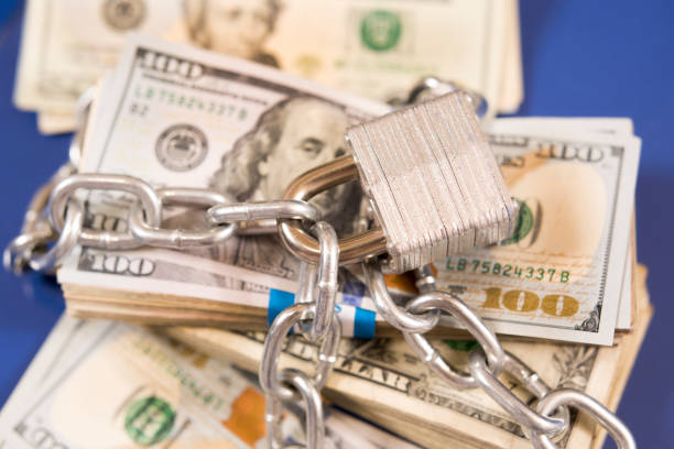 istock American paper currency under lock and chain. 1316994475