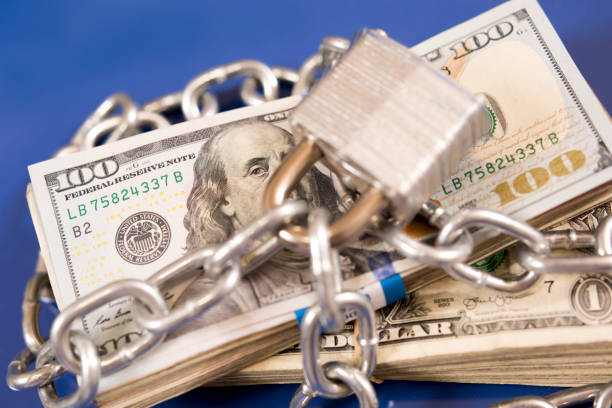 istock American paper currency under lock and chain. 1316994477