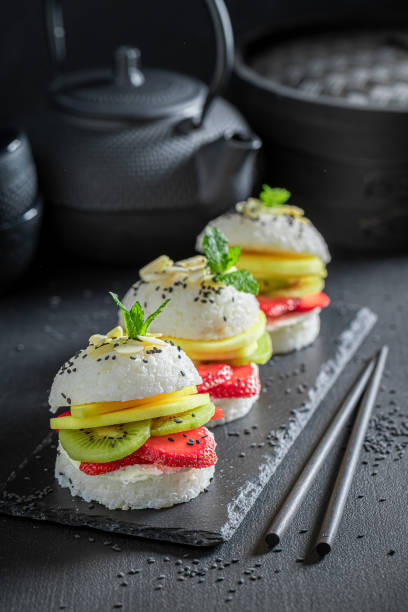 istock Exquisite sush burger with fresh tropical fruits sprinkled with sesame. 1316995591