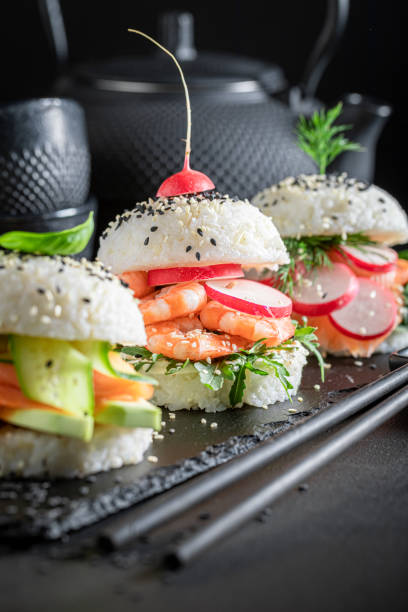 istock Delicious sush burger with salmon and avocado sprinkled with sesame. 1316995788