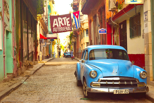 Vintage car parked on cobblestone street in Havana, Cuba