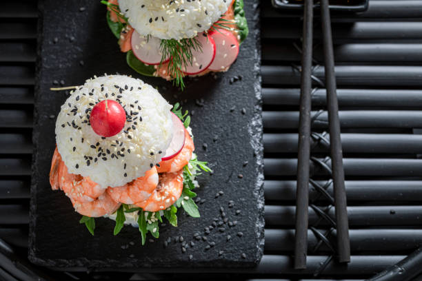istock Exquisite sush burger with salmon and avocado as Japanese appetizers. 1316995878
