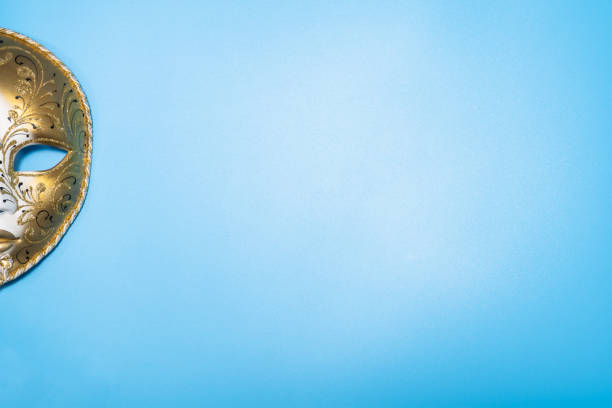 istock Half of Venetian carnival masquerade mask on blue background. Copy space. 1316995883