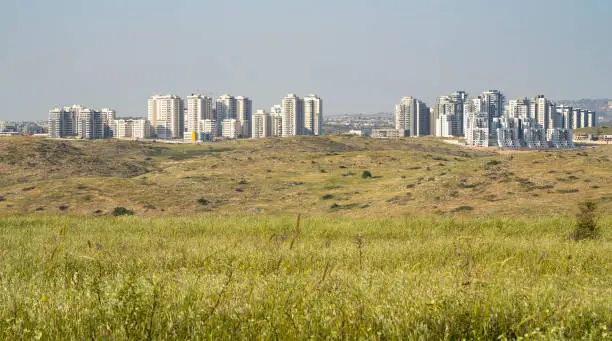 A panoramic view of Rosh Haayin, Israel, and the nature surrounding it, on a clear, sunny day.