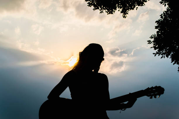 istock Sitting woman playing the guitar 1317002693