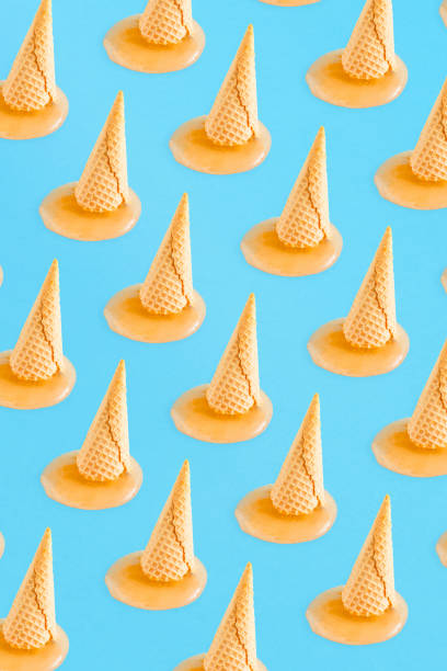 istock Summer pattern background  with ice cream cone and orange that melts on a light blue background. Healthy diet or nature concept. Minimal summer food. 1317004781