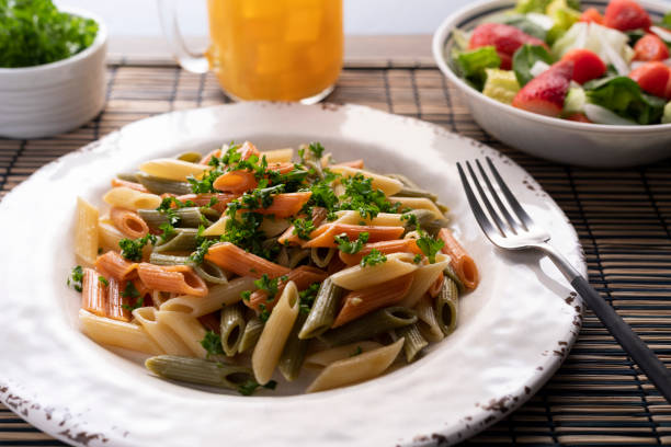 butter penne pasta with parsley, lettuce, tomato and strawberry salad
