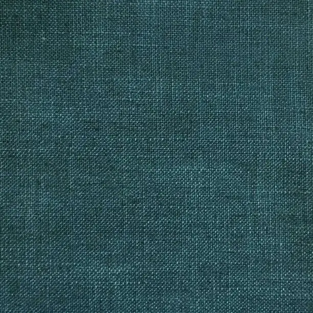 Photo of Burlap polyester linen blend upholstery fabric texture for home decor in teal blue