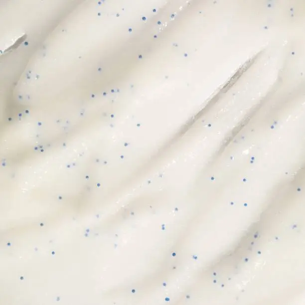 White peeling gel texture with blue scrub flecks