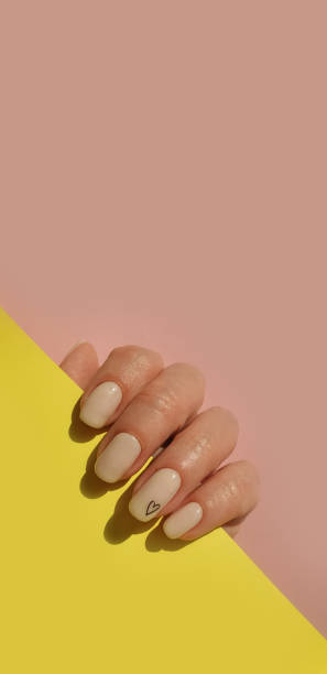istock female hand beautiful beige manicure on a colored background 1317008070