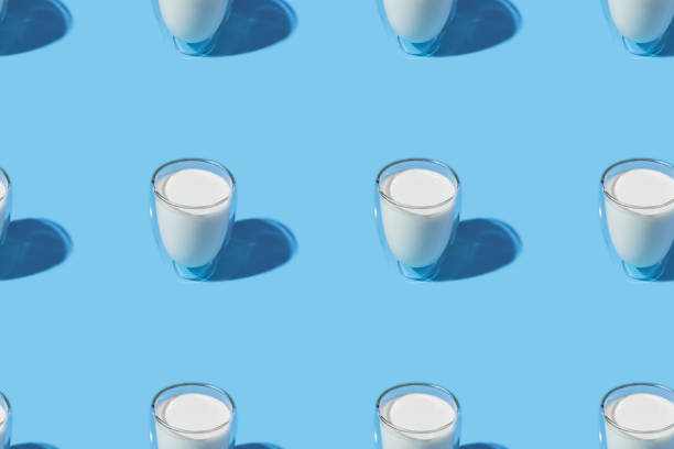 istock World Milk Day. Pattern on a blue background. A glass of milk. Pattern. 1317008167
