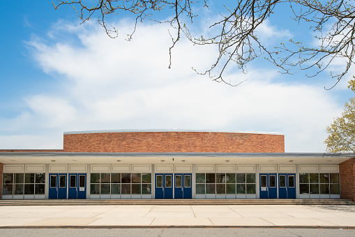 Exterior view of a typical American school building seen on a spring day