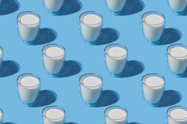 World Milk Day. Pattern on a blue background. A glass of milk. Pattern.