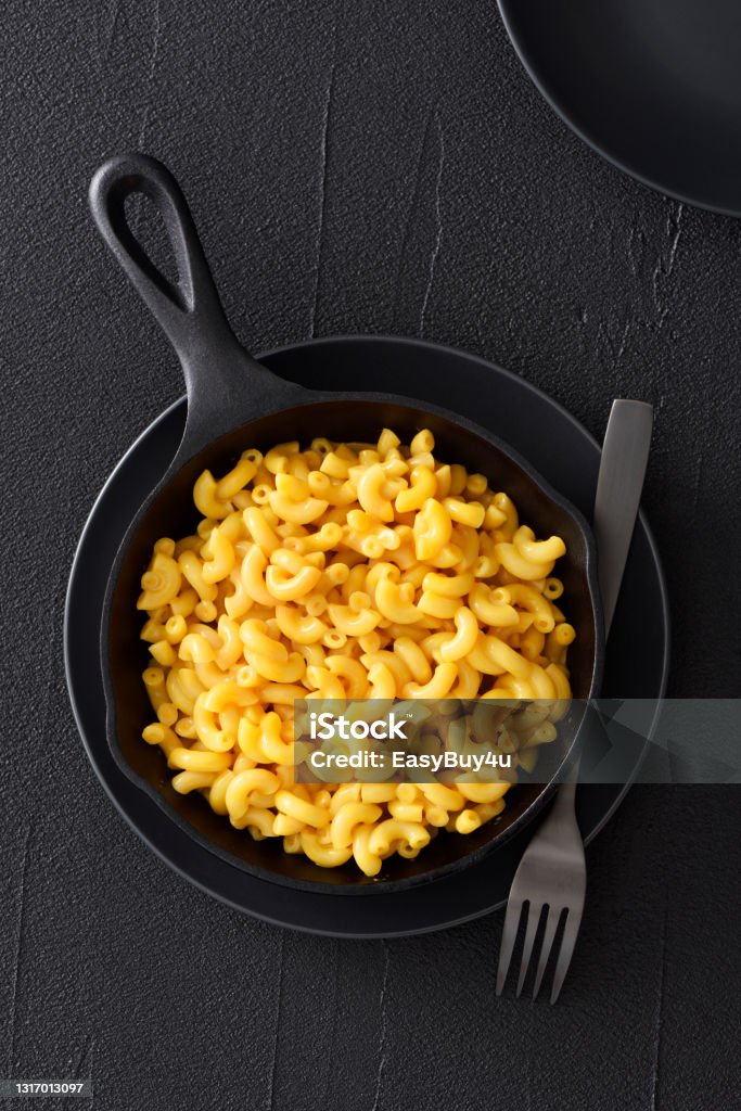 Macaroni and cheese Macaroni and cheese in cast iron skillet on a black background Macaroni and Cheese Stock Photo