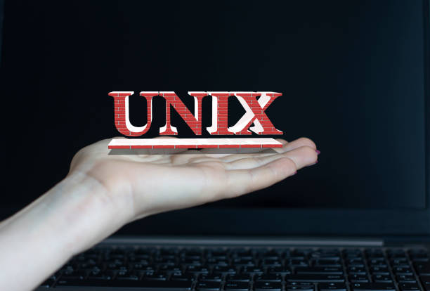 unix - word on a woman's hand against the background of a laptop - unix imagens e fotografias de stock