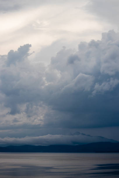 istock Dramatic clouds over lake and mountains at dusk 1317015271