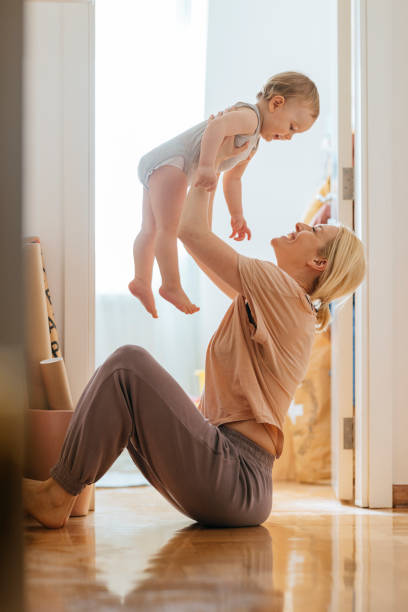 istock Cheerful mother playing with daughter at home 1317017397