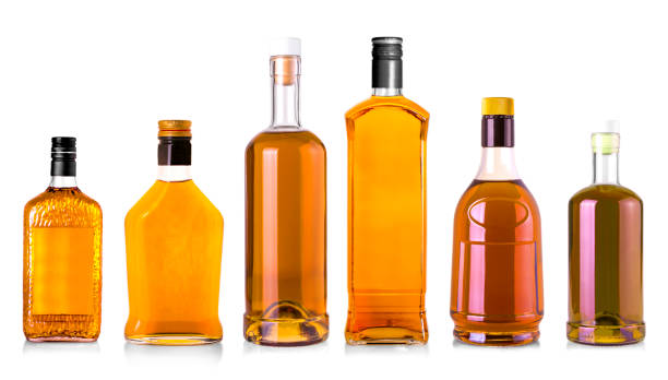 istock Full whiskey bottles isolated on white background 1317025348