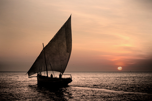 A traditional dhow at sunset near Stone Town, Zanzibar, Tanzania