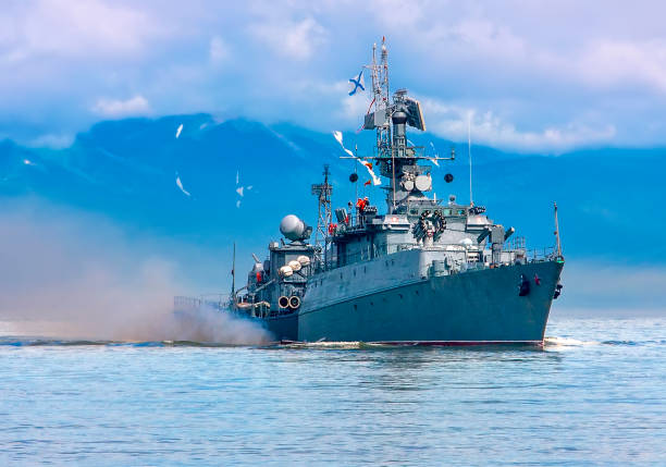 russian warship going along the coast. selective focus - destroyer imagens e fotografias de stock