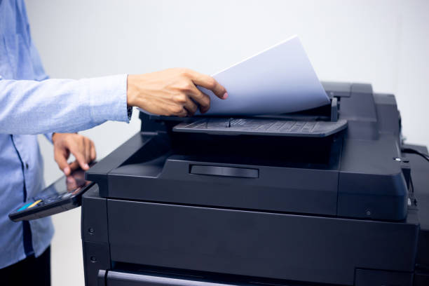 istock Bussiness man Hand press button on panel of printer, printer scanner laser in office copy machine supplies start concept. 1317035518