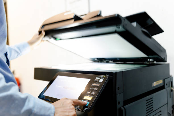 istock Bussiness man Hand press button on panel of printer, printer scanner laser in office copy machine supplies start concept. 1317035539