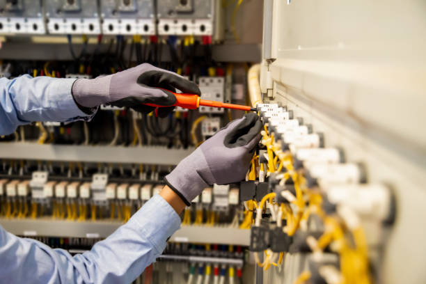istock Electricians work to connect electric wires in the system, switchboard, electrical system in Control cabinet. 1317035565