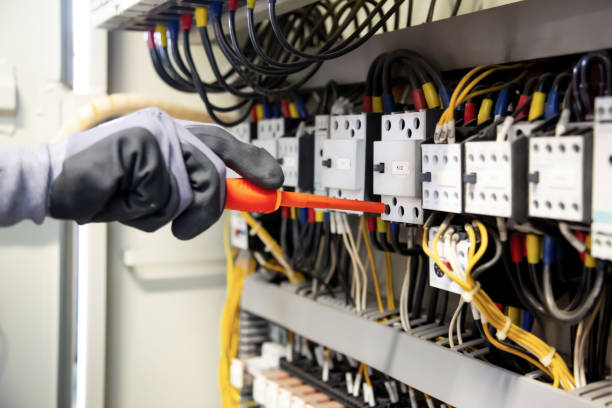 istock Electricians work to connect electric wires in the system, switchboard, electrical system in Control cabinet. 1317035584