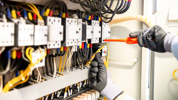 istock Electricians work to connect electric wires in the system, switchboard, electrical system in Control cabinet. 1317036129