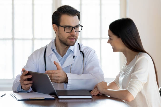 istock Male doctor consult female patient using tablet 1317036241
