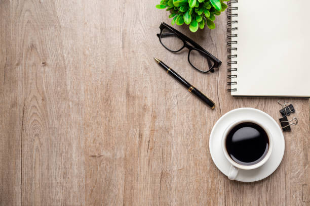 istock Flat lay, top view office table desk. Workspace with, laptop,office supplies, pencil, green leaf, and coffee cup on wood background. 1317036298
